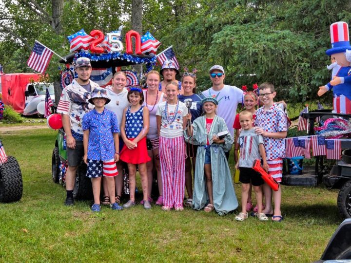 Family group in patriotic outfits at Fourth of July parade