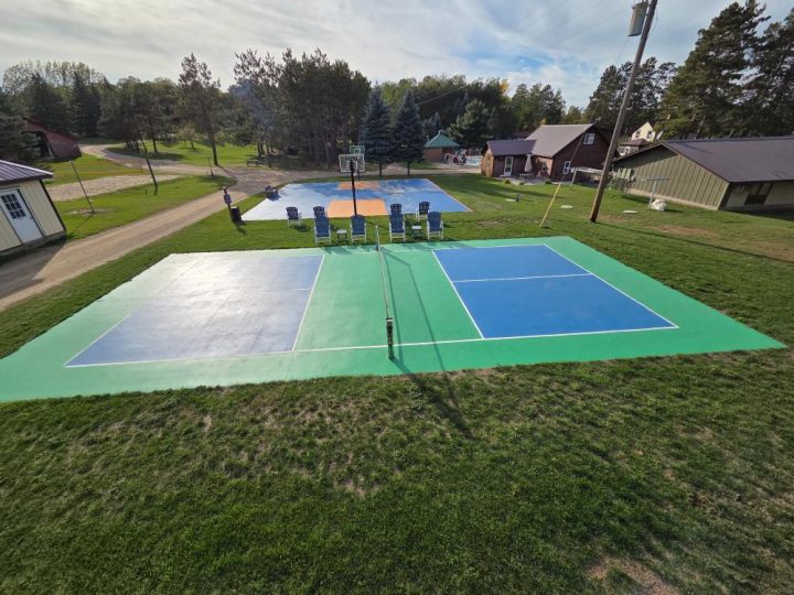 Outdoor pickleball and basketball courts at a rural camp