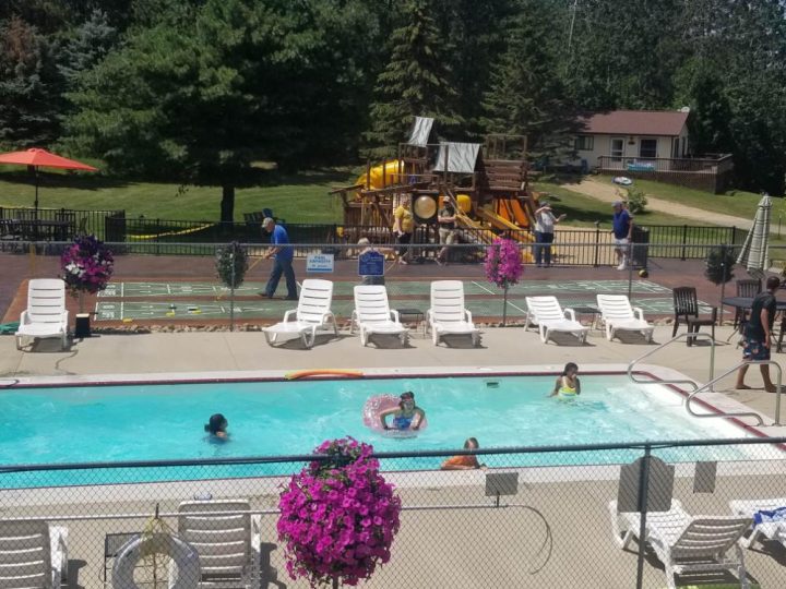 Outdoor resort pool with playground and lounge chairs